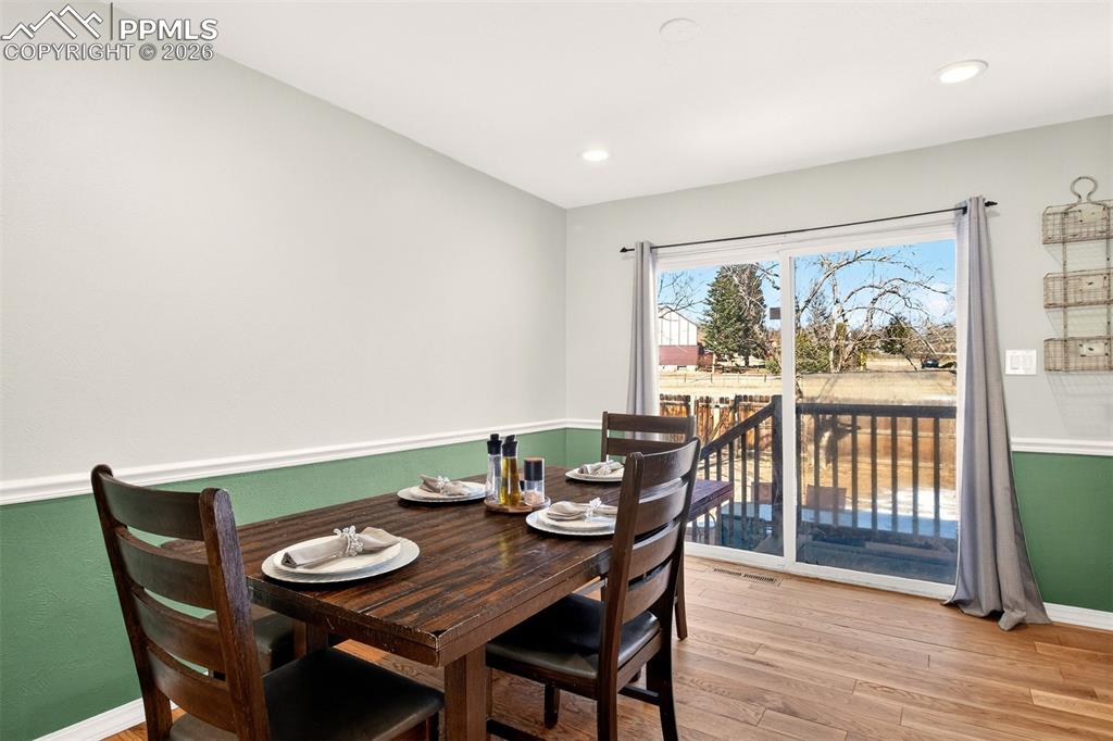 5226 Rocking R Drive Colorado Springs, CO 80915 - Photo 14 of 46 a view of a dining room with furniture window and wooden floor