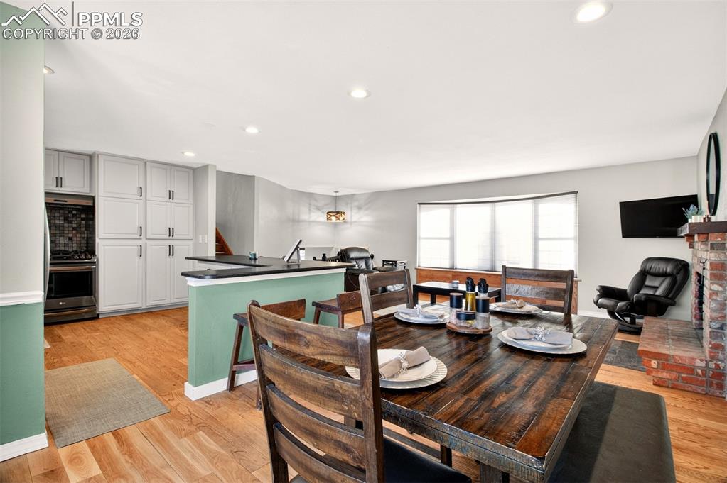 5226 Rocking R Drive Colorado Springs, CO 80915 - Photo 15 of 46 a view of a dining room with furniture window and wooden floor