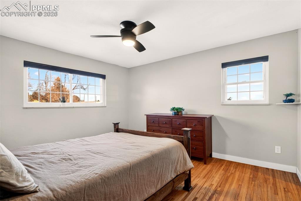5226 Rocking R Drive Colorado Springs, CO 80915 - Photo 20 of 46 a bedroom with a bed and wooden floor