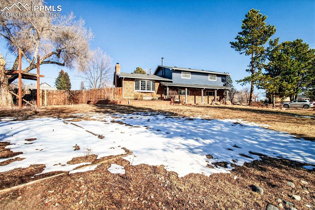 5226 Rocking R Drive Colorado Springs, CO 80915 - Photo 2 of 46 a front view of a house with a yard