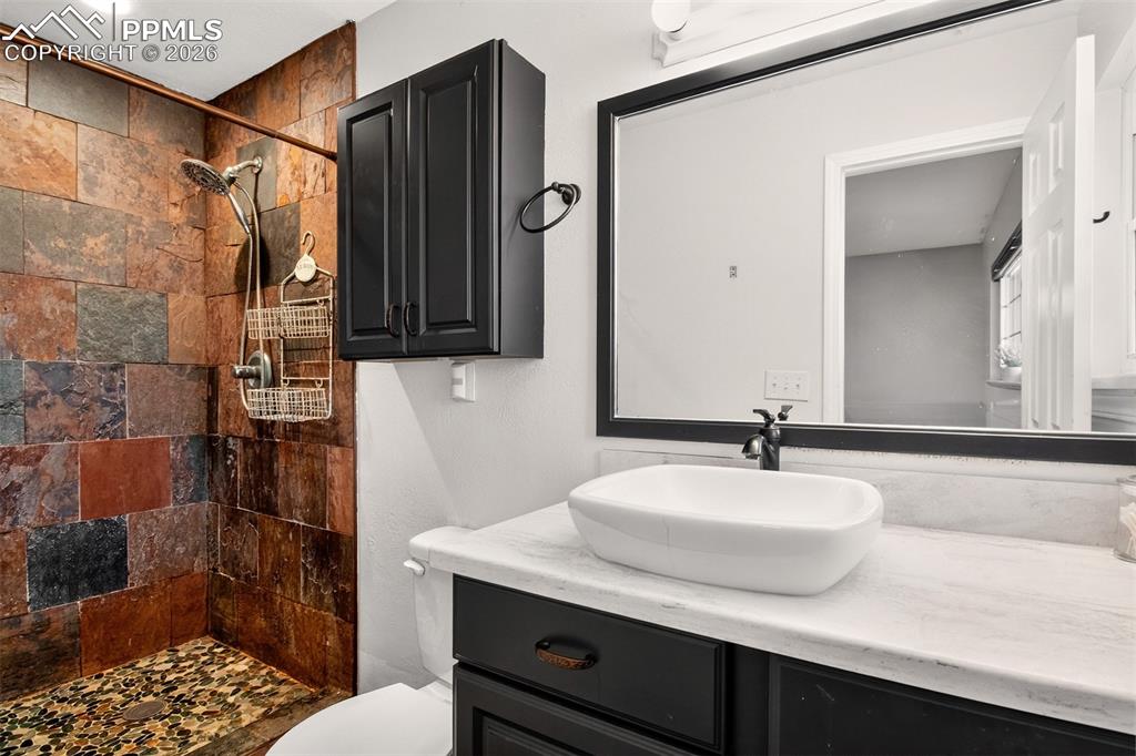 5226 Rocking R Drive Colorado Springs, CO 80915 - Photo 22 of 46 a bathroom with a sink and a mirror