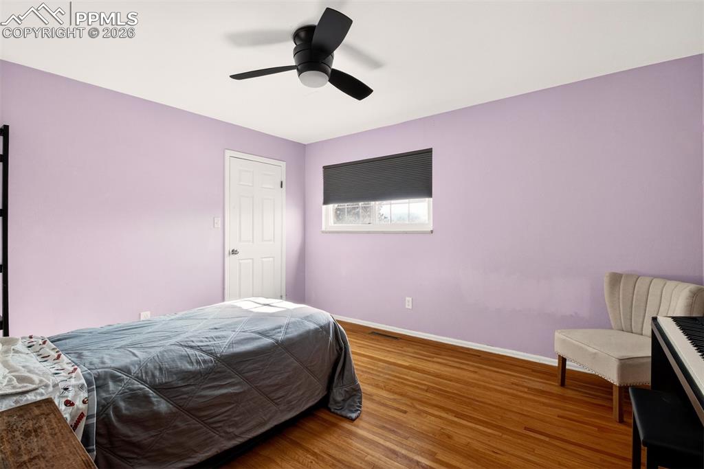 5226 Rocking R Drive Colorado Springs, CO 80915 - Photo 23 of 46 a bedroom with a bed and a wooden floor