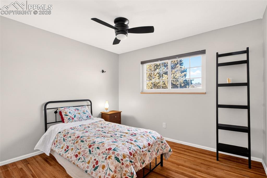 5226 Rocking R Drive Colorado Springs, CO 80915 - Photo 29 of 46 a bedroom with a large bed and a painting on the wall