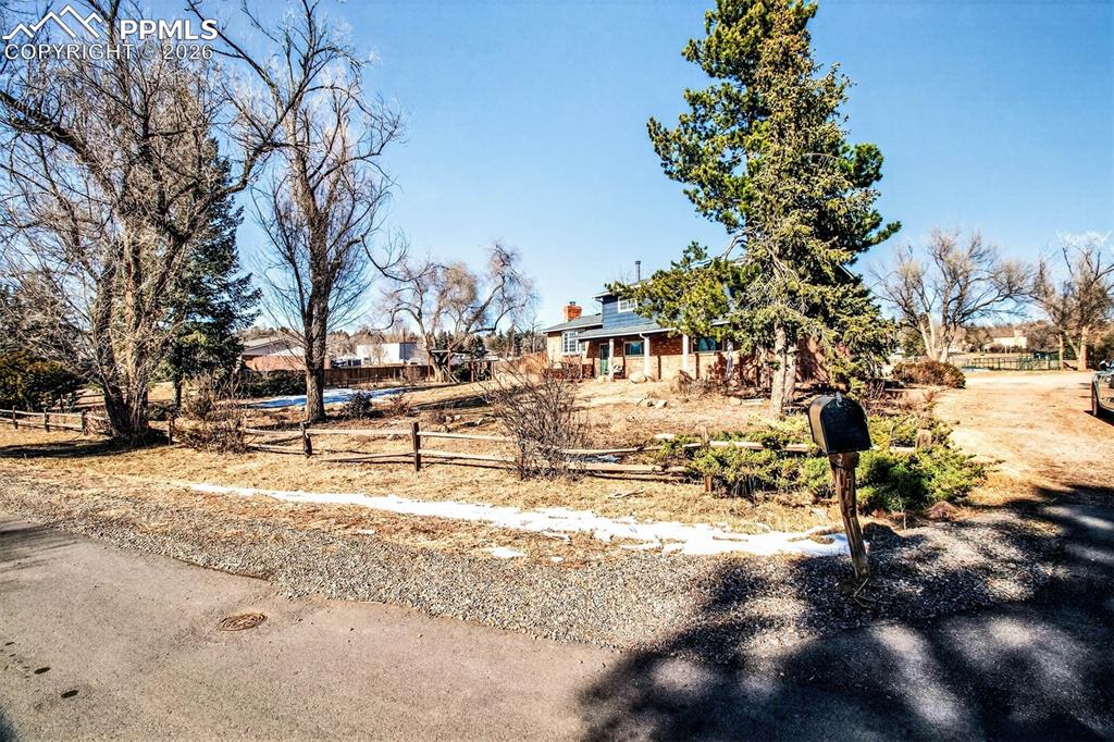 5226 Rocking R Drive Colorado Springs, CO 80915 - Photo 3 of 46 a view of a yard with trees