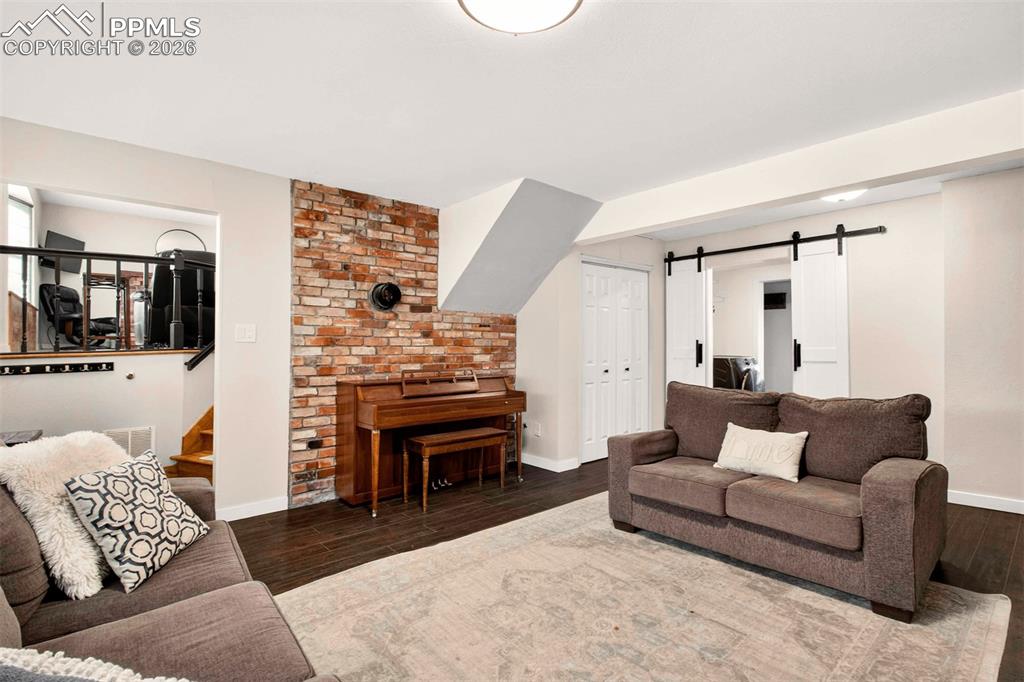 5226 Rocking R Drive Colorado Springs, CO 80915 - Photo 32 of 46 a living room with furniture and a flat screen tv