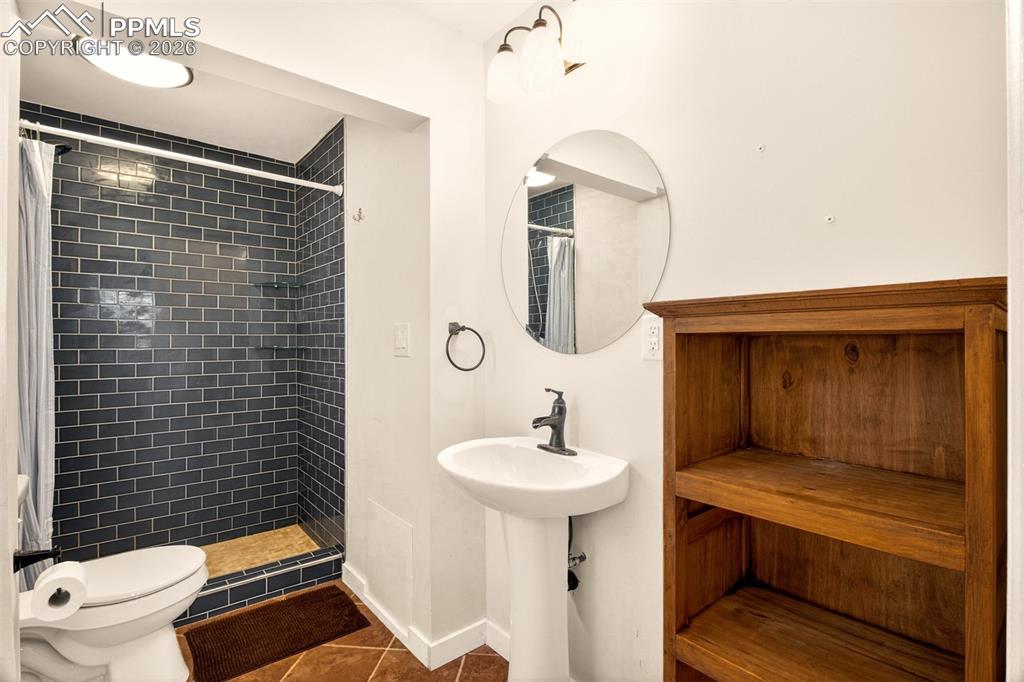 5226 Rocking R Drive Colorado Springs, CO 80915 - Photo 37 of 46 a bathroom with a sink toilet and shower