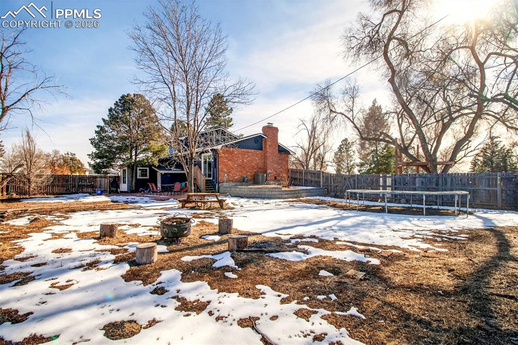 5226 Rocking R Drive Colorado Springs, CO 80915 - Photo 42 of 46 a view of a yard with snow on the road