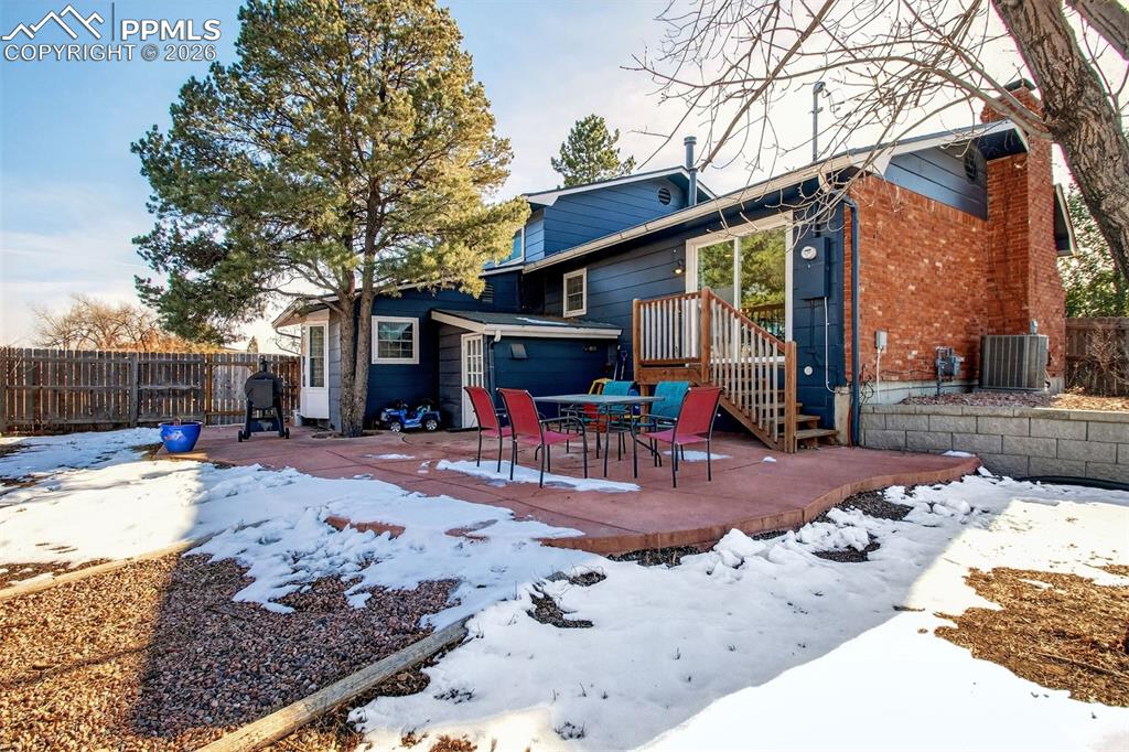5226 Rocking R Drive Colorado Springs, CO 80915 - Photo 43 of 46 a view of a house with a patio covered with snow