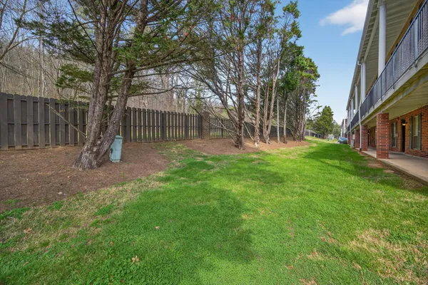 a view of a backyard with a garden and deck