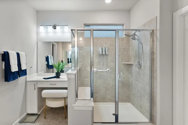 a bathroom with a shower a sink and mirror