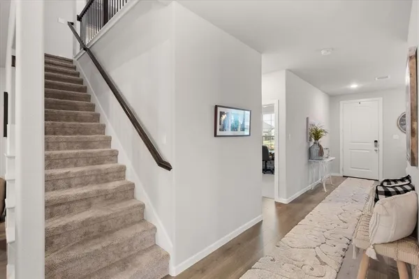 a view of entryway with furniture and wooden floor