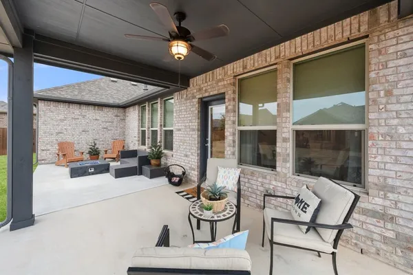 a view of a patio with table and chairs and potted plants