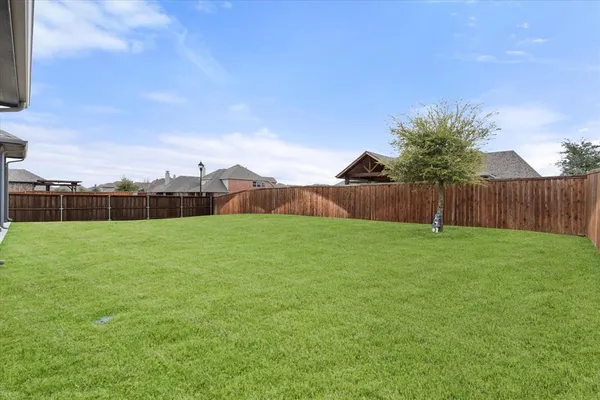 a view of yard with swimming pool and green space