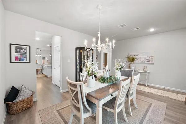 a view of a dining room with furniture and chandelier