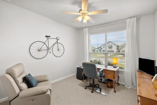 a living room with furniture a chandelier and a window