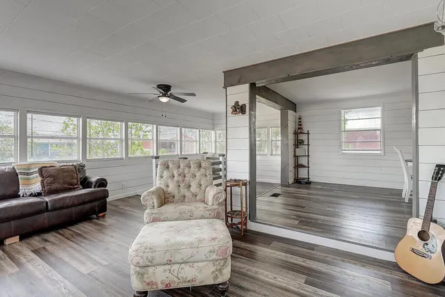 a living room with furniture and wooden floor