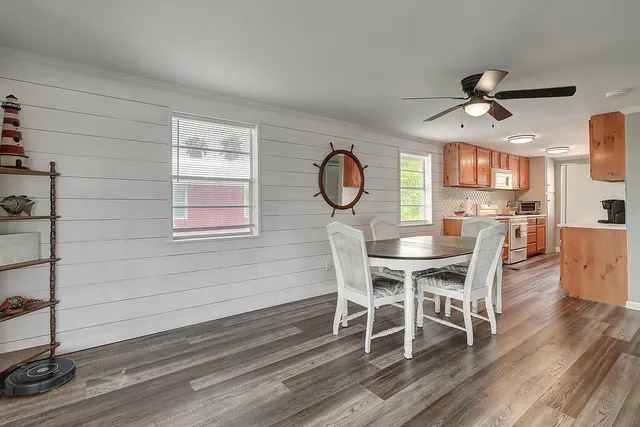 a view of a dining room with furniture window and wooden floor