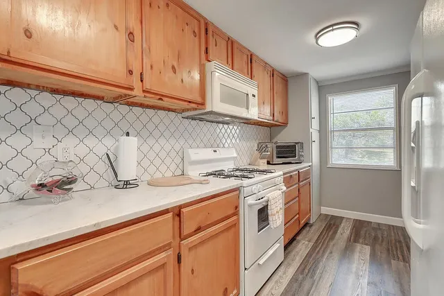 a kitchen with stainless steel appliances granite countertop a sink and a stove
