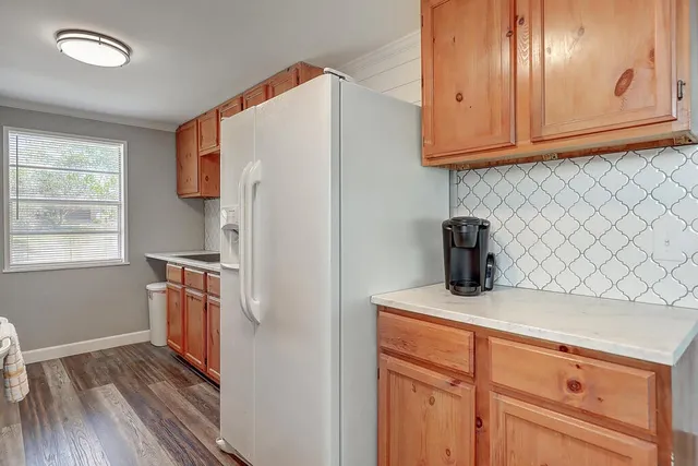 a kitchen with stainless steel appliances granite countertop a refrigerator sink and cabinets
