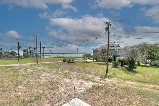 a view of a swimming pool with a yard