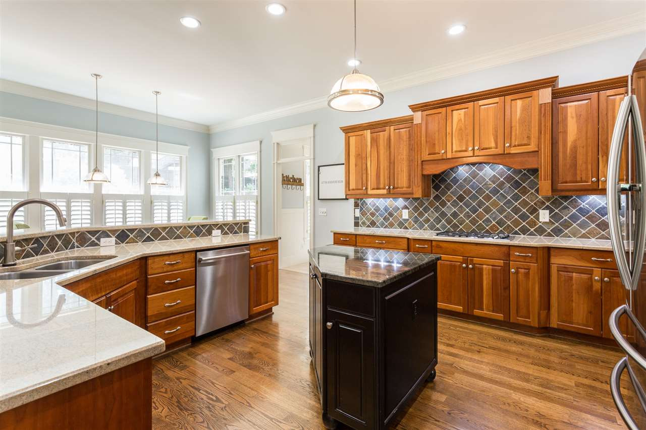 1716 Stannard Trail Raleigh, NC 27612 - Photo 9 of 30 The kitchen offers updated stainless appliances, abundant counter space with granite counter tops, under cabinet lighting and tile backsplash.The kitchen refrigerator conveys! A Kitchen that is a Chef's Delight