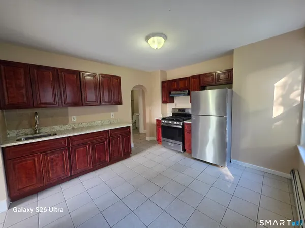 a kitchen with stainless steel appliances granite countertop a refrigerator sink and cabinets