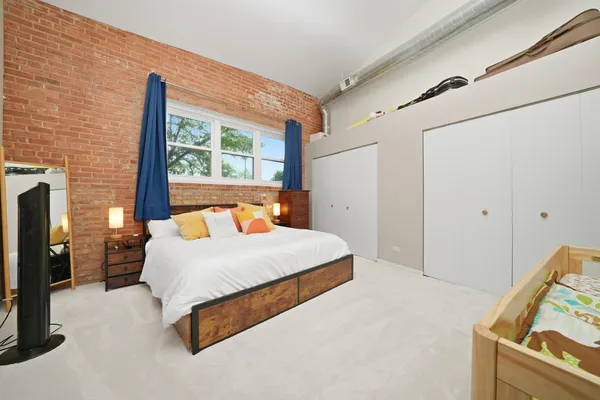 a bedroom with a bed and a large window