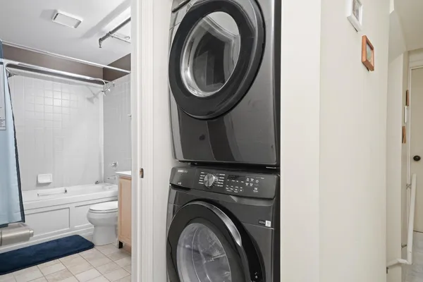 a view of bathroom with washing machine and mirror