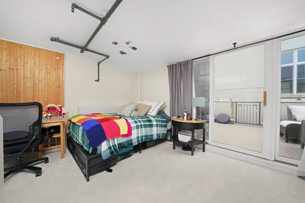 a bed room with furniture and a flat screen tv