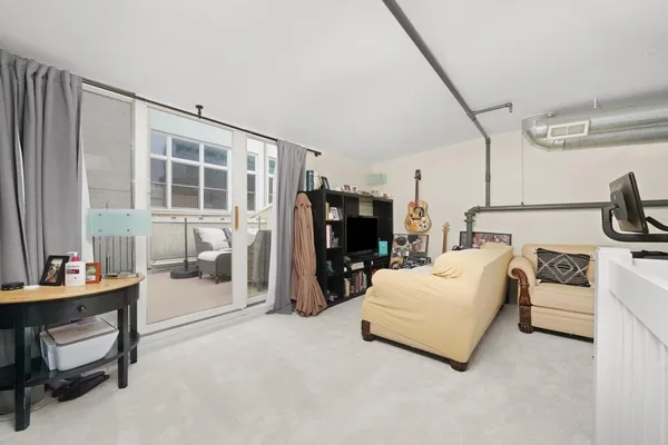 a balcony with wooden floor and furniture