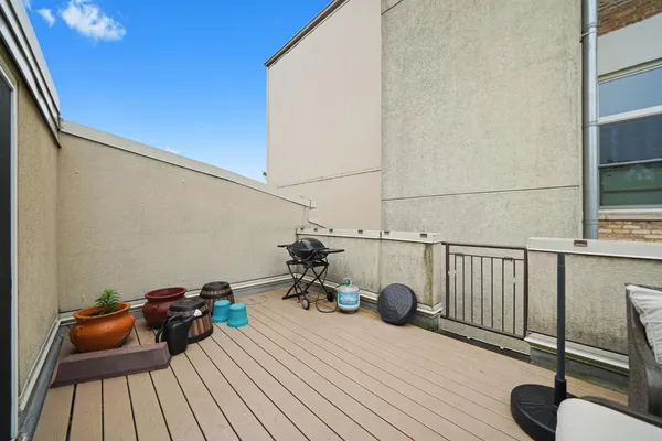 a view of a balcony with couch and wooden floor
