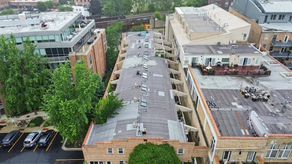 an aerial view of multiple houses with a yard