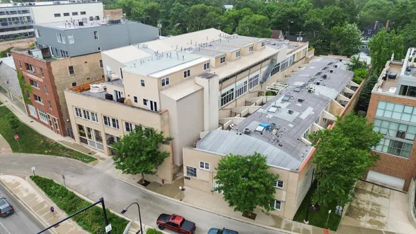 an aerial view of a house with a big yard