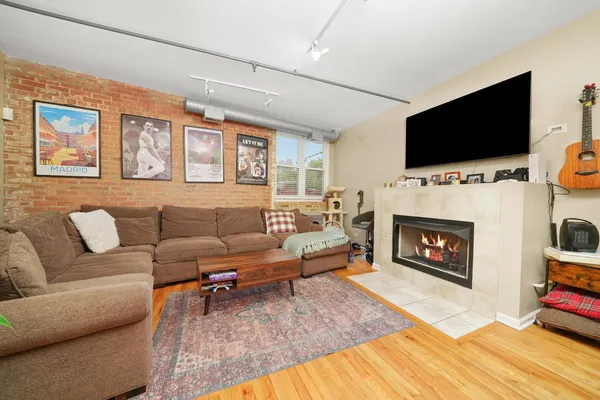 a living room with fireplace furniture and a flat screen tv