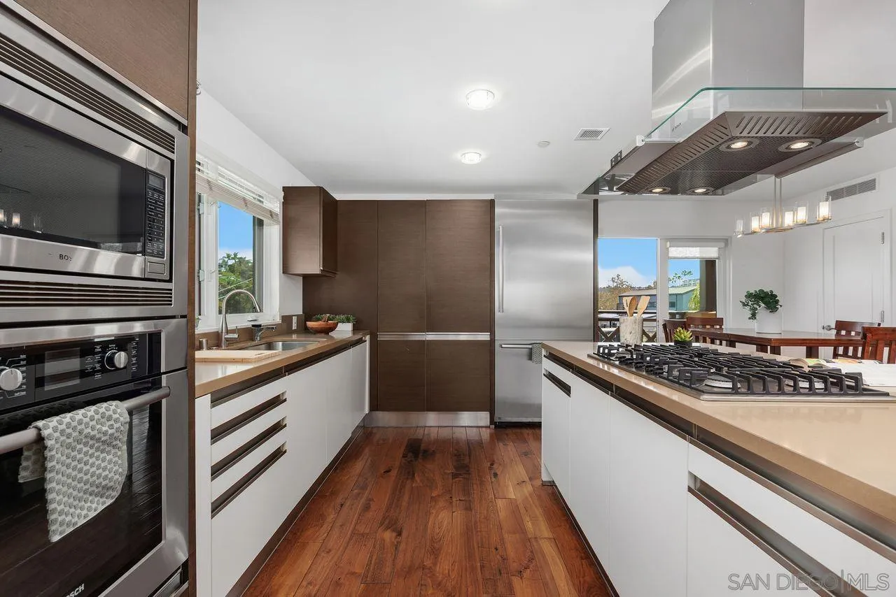 90 North Coast Highway 101 Encinitas, CA 92024 - Photo 16 of 39 a kitchen with stainless steel appliances a sink and cabinets