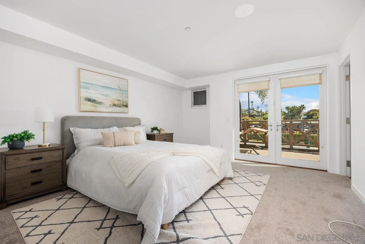 90 North Coast Highway 101 Encinitas, CA 92024 - Photo 22 of 39 a bedroom with a large bed and a window