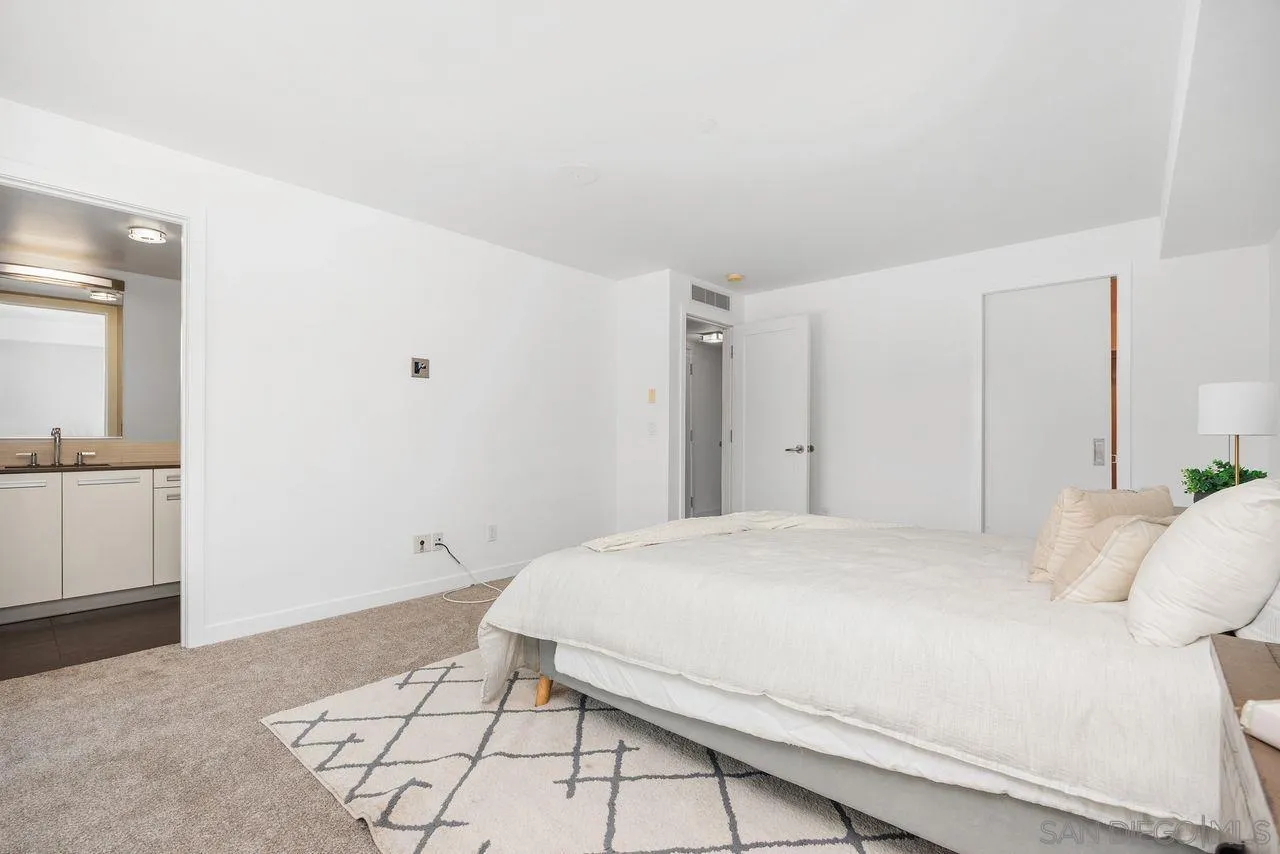 90 North Coast Highway 101 Encinitas, CA 92024 - Photo 23 of 39 a bedroom with a bed and a view of bathroom