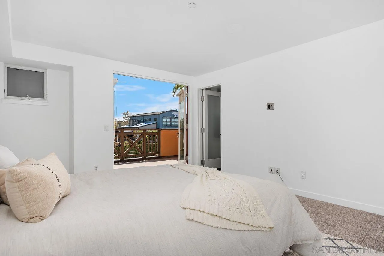 90 North Coast Highway 101 Encinitas, CA 92024 - Photo 24 of 39 a room with a bed and a fireplace