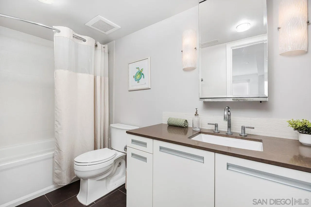 90 North Coast Highway 101 Encinitas, CA 92024 - Photo 29 of 39 a bathroom with a sink toilet and shower