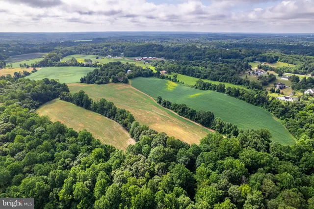 an aerial view of a house with a garden and trees