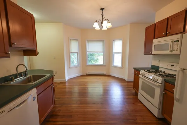 a kitchen with a sink stove top oven and cabinets