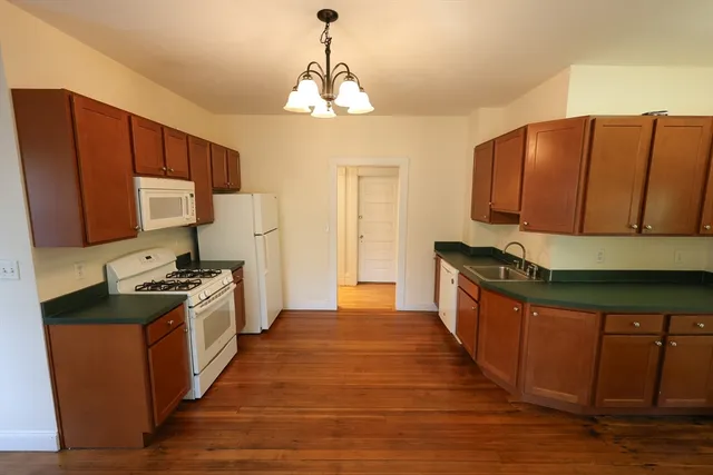 a kitchen with stainless steel appliances granite countertop a stove a sink dishwasher and a refrigerator
