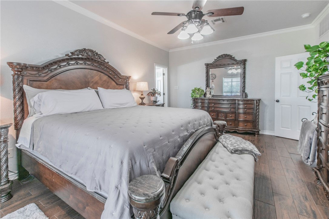 876 South St Joseph Road Burlington, TX 76519 - Photo 13 of 35 a bedroom with a bed and wooden floor