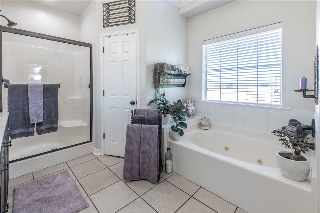876 South St Joseph Road Burlington, TX 76519 - Photo 16 of 35 a white bath tub sitting in a bathroom and mirror