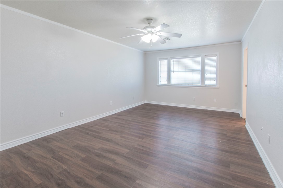 876 South St Joseph Road Burlington, TX 76519 - Photo 17 of 35 a view of an empty room with wooden floor and a window