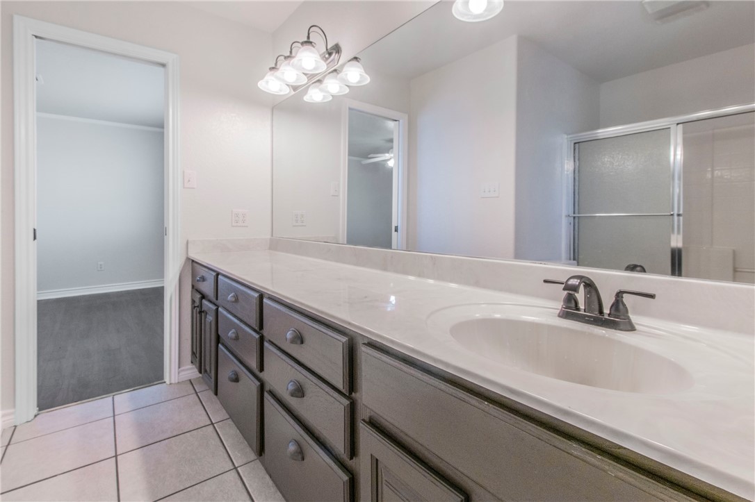 876 South St Joseph Road Burlington, TX 76519 - Photo 18 of 35 a bathroom with a double vanity sink and a mirror