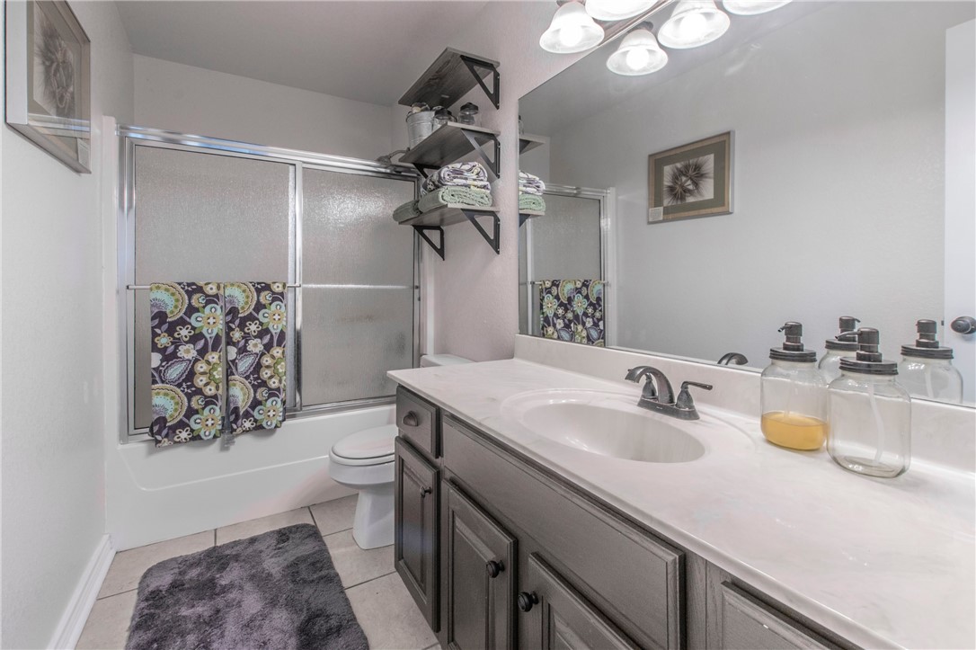 876 South St Joseph Road Burlington, TX 76519 - Photo 21 of 35 a bathroom with a sink a toilet and shower curtain