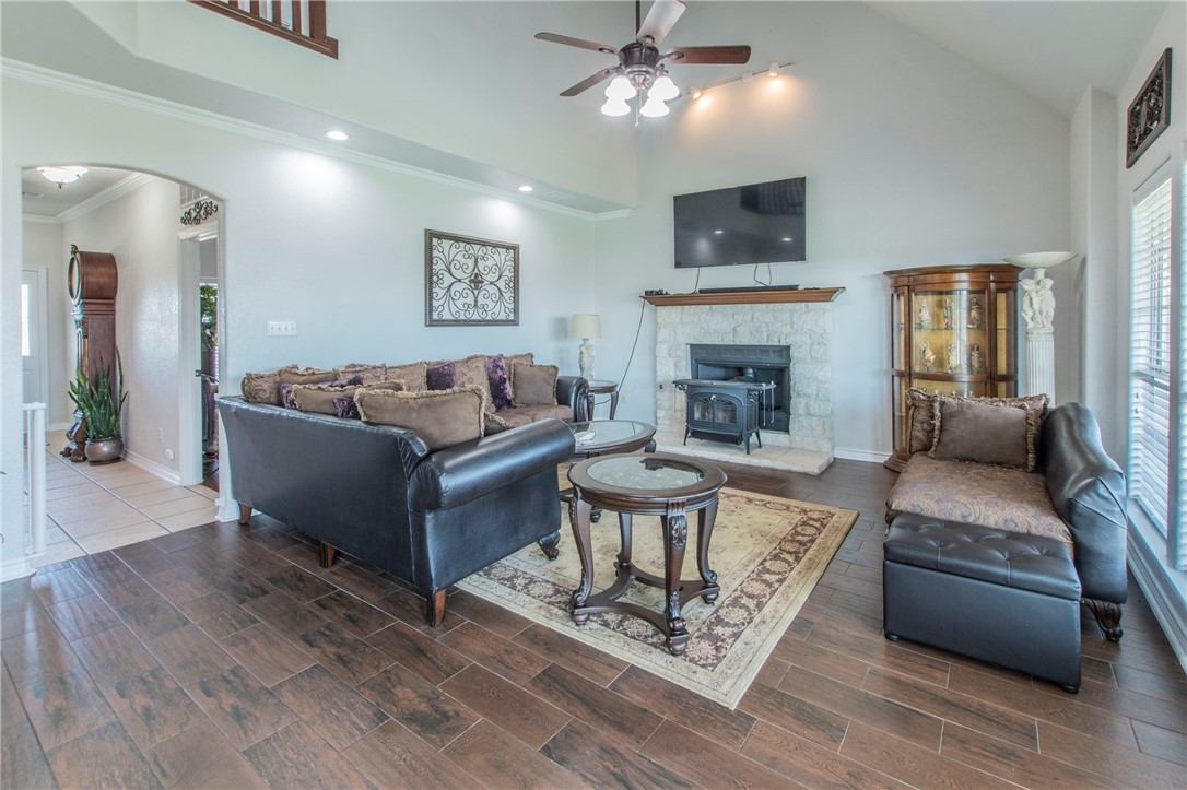 876 South St Joseph Road Burlington, TX 76519 - Photo 5 of 35 a living room with furniture a fireplace and a flat screen tv