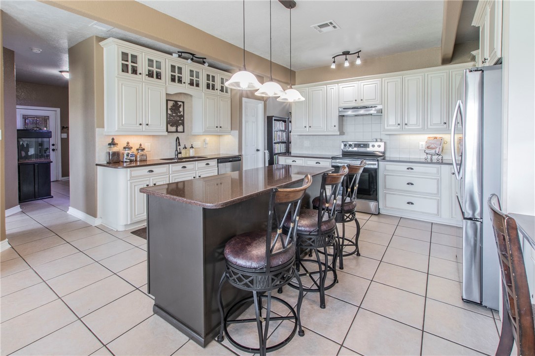 876 South St Joseph Road Burlington, TX 76519 - Photo 8 of 35 a kitchen with kitchen island a counter top space appliances and cabinets