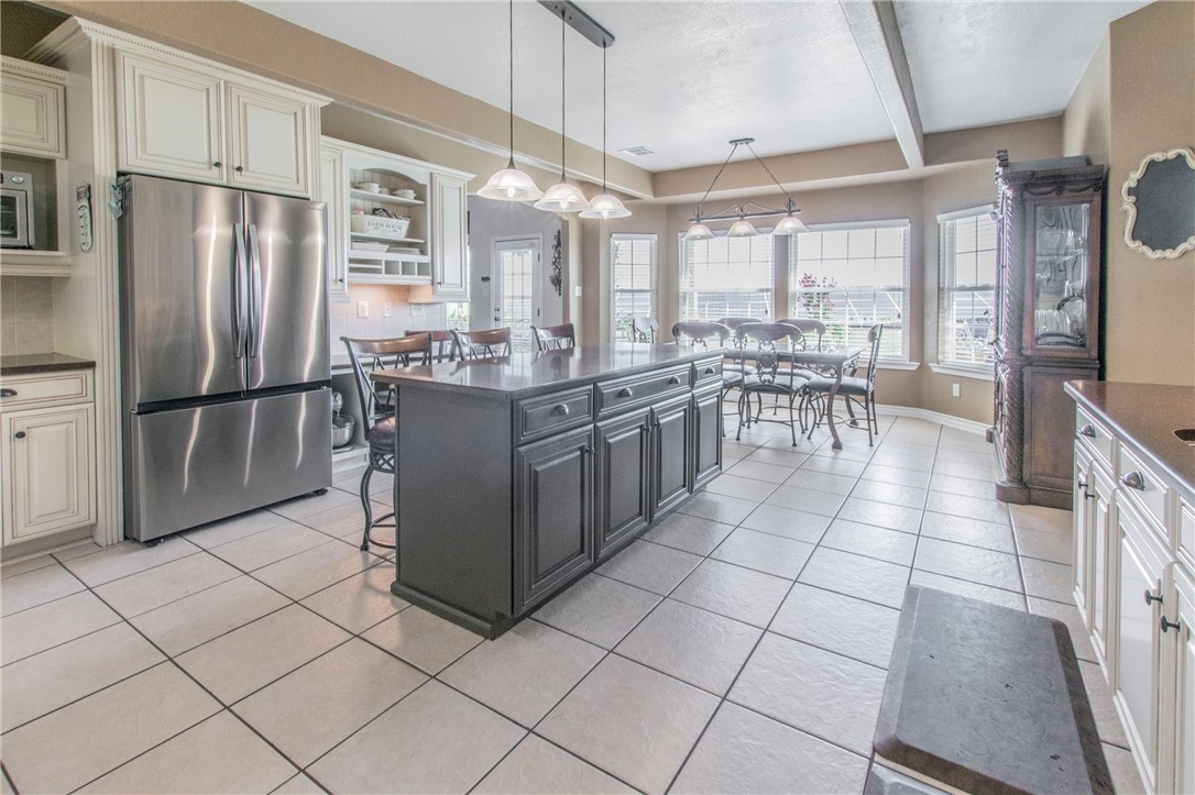 876 South St Joseph Road Burlington, TX 76519 - Photo 9 of 35 a kitchen with stainless steel appliances granite countertop a refrigerator and a stove